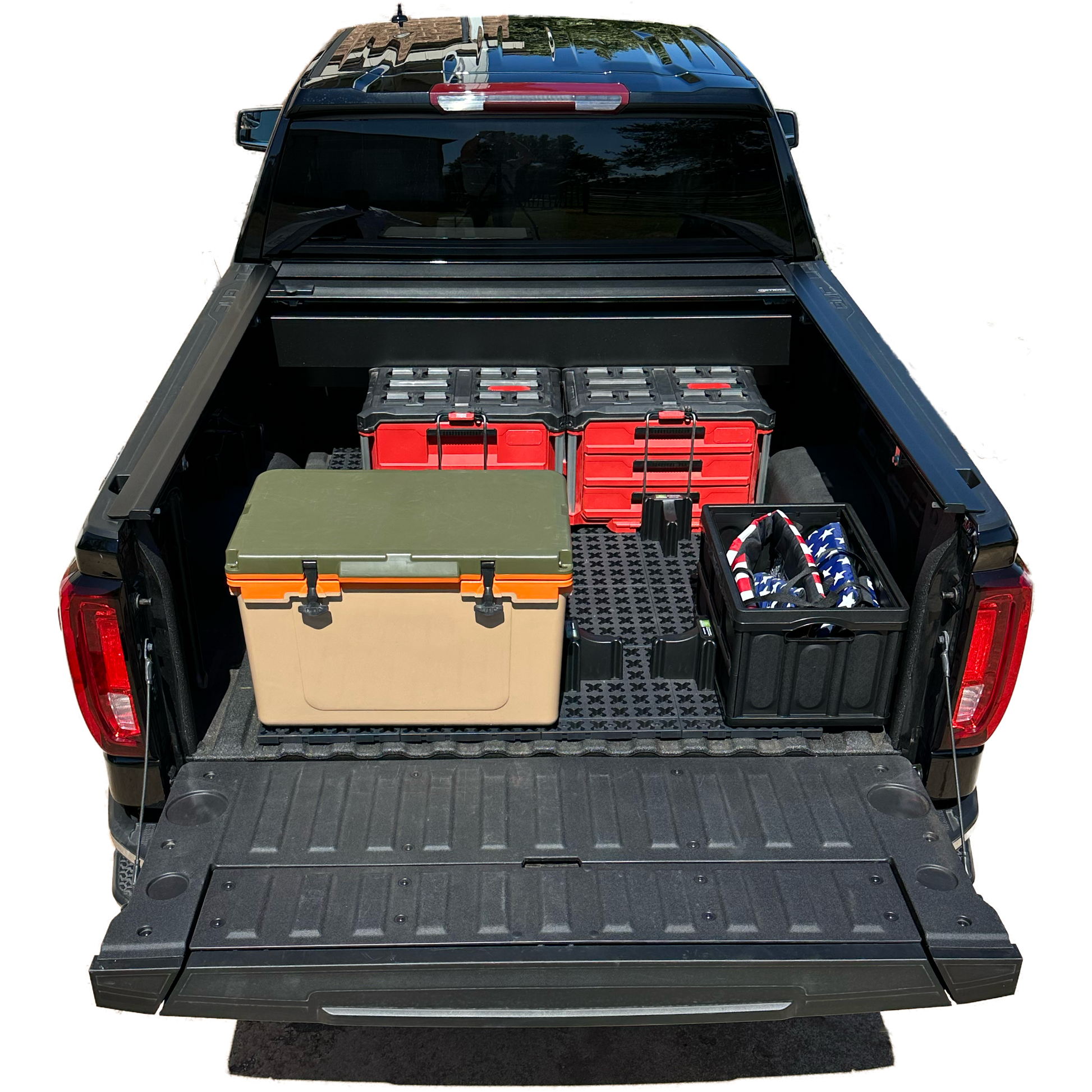 GMC short bed truck with Tmat securing boxes and a cooler